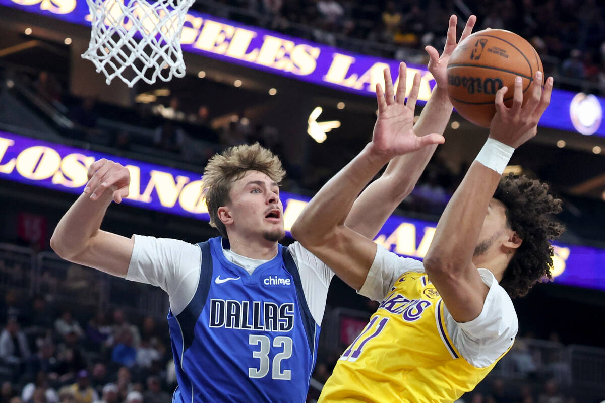 Dallas Mavericks forward Cooper Flagg (32) blocks a shot from Los Angeles Lakers center Jaxson ...