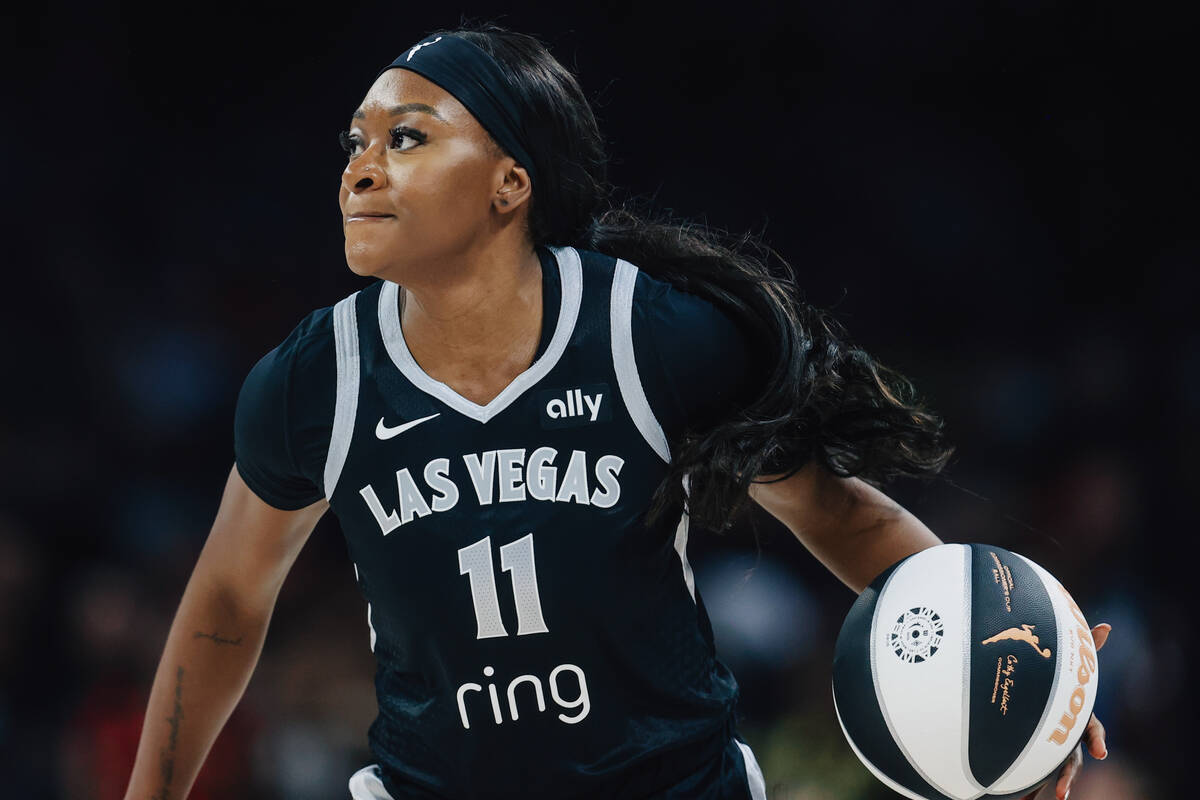 Aces guard Dana Evans (11) dribbles the ball during a WNBA basketball game between the Aces and ...