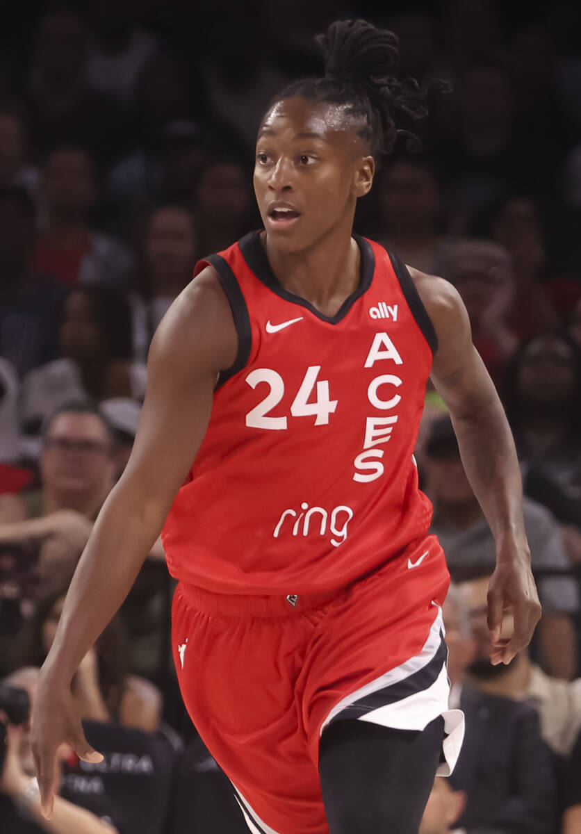 Aces guard Jewell Loyd (24) brings the ball up court past Atlanta Dream guard Allisha Gray (15) ...