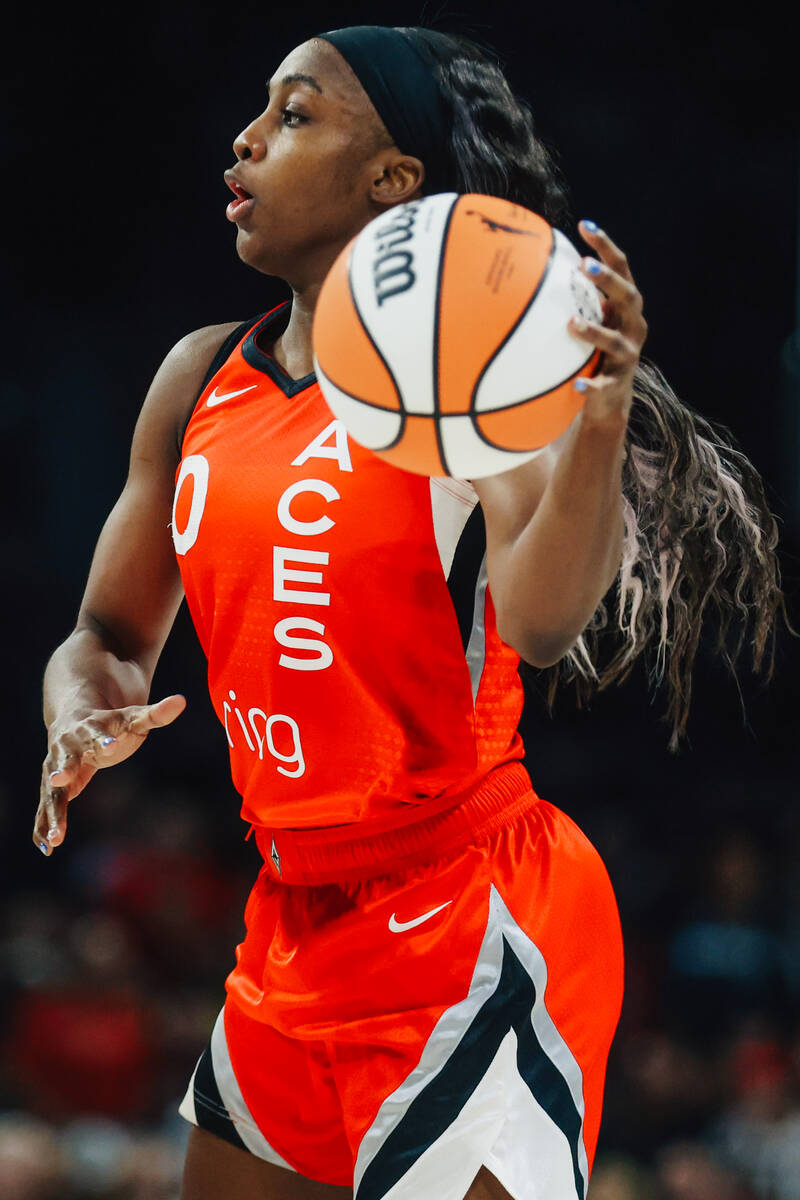 Aces guard Jackie Young (0) dribbles the ball during a WNBA basketball game between the Aces an ...