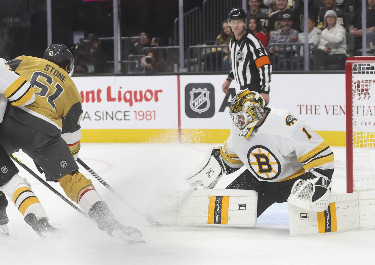 Boston Bruins goaltender Jeremy Swayman (1) stops a shot from Golden Knights right wing Mark St ...