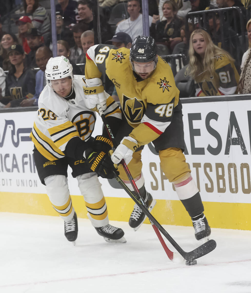 Golden Knights center Tomas Hertl (48) and Boston Bruins defenseman Henri Jokiharju (20) battle ...