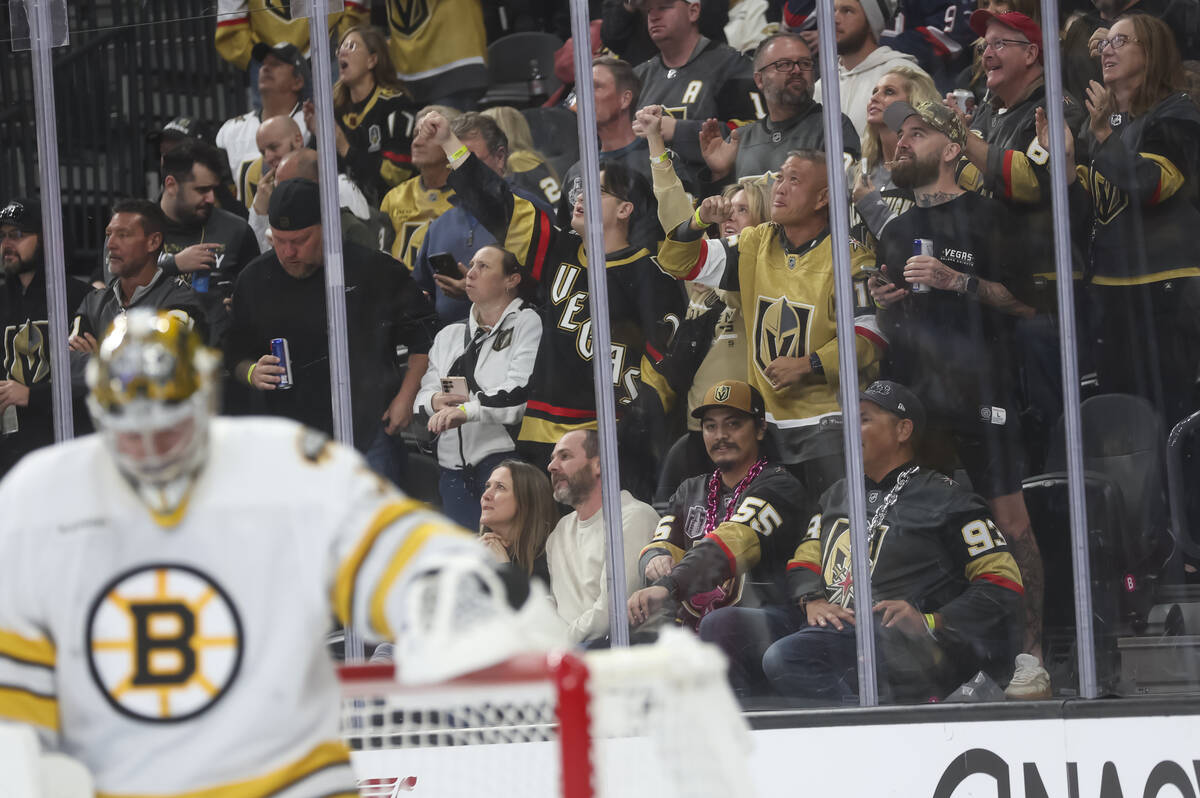 Golden Knights fans celebrate a goal against the Boston Bruins during the first period of an NH ...