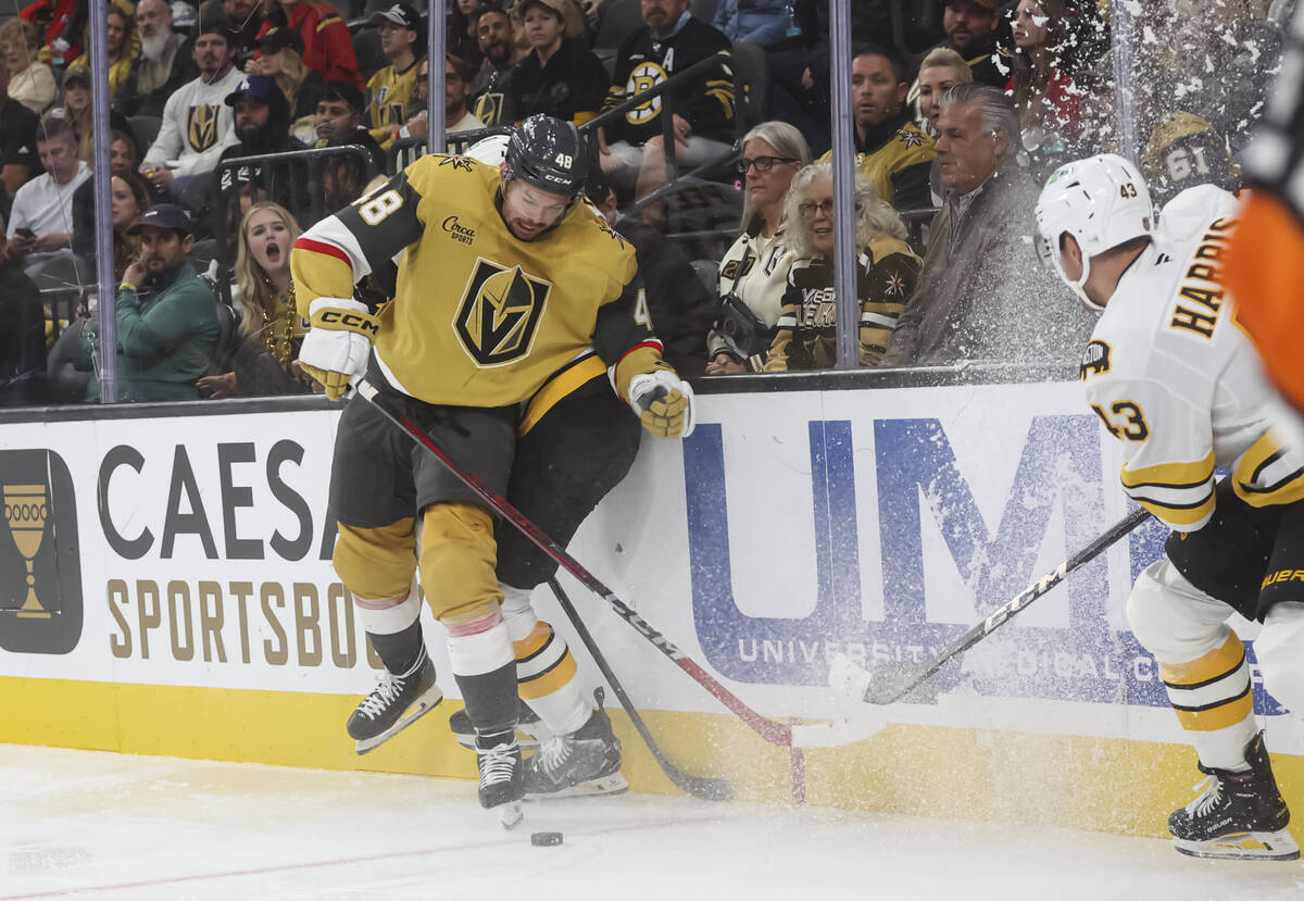 Golden Knights center Tomas Hertl (48) eyes the puck under pressure from the Boston Bruins duri ...