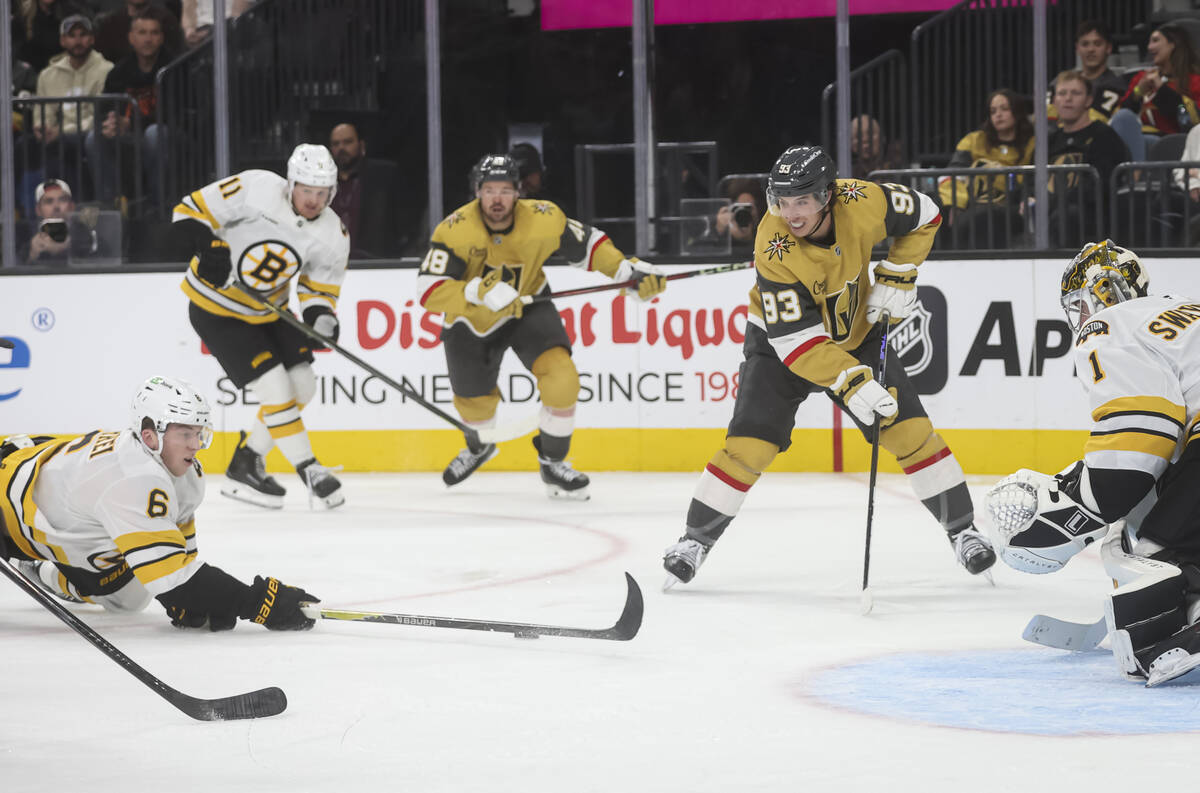 Boston Bruins defenseman Mason Lohrei (6) blocks the pass of Golden Knights right wing Mitch Ma ...
