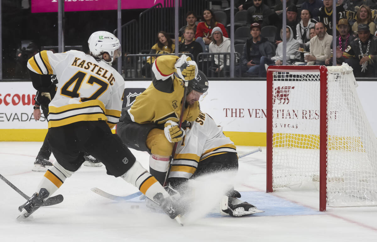Golden Knights center Tomas Hertl (48) collides with Boston Bruins goaltender Jeremy Swayman (1 ...