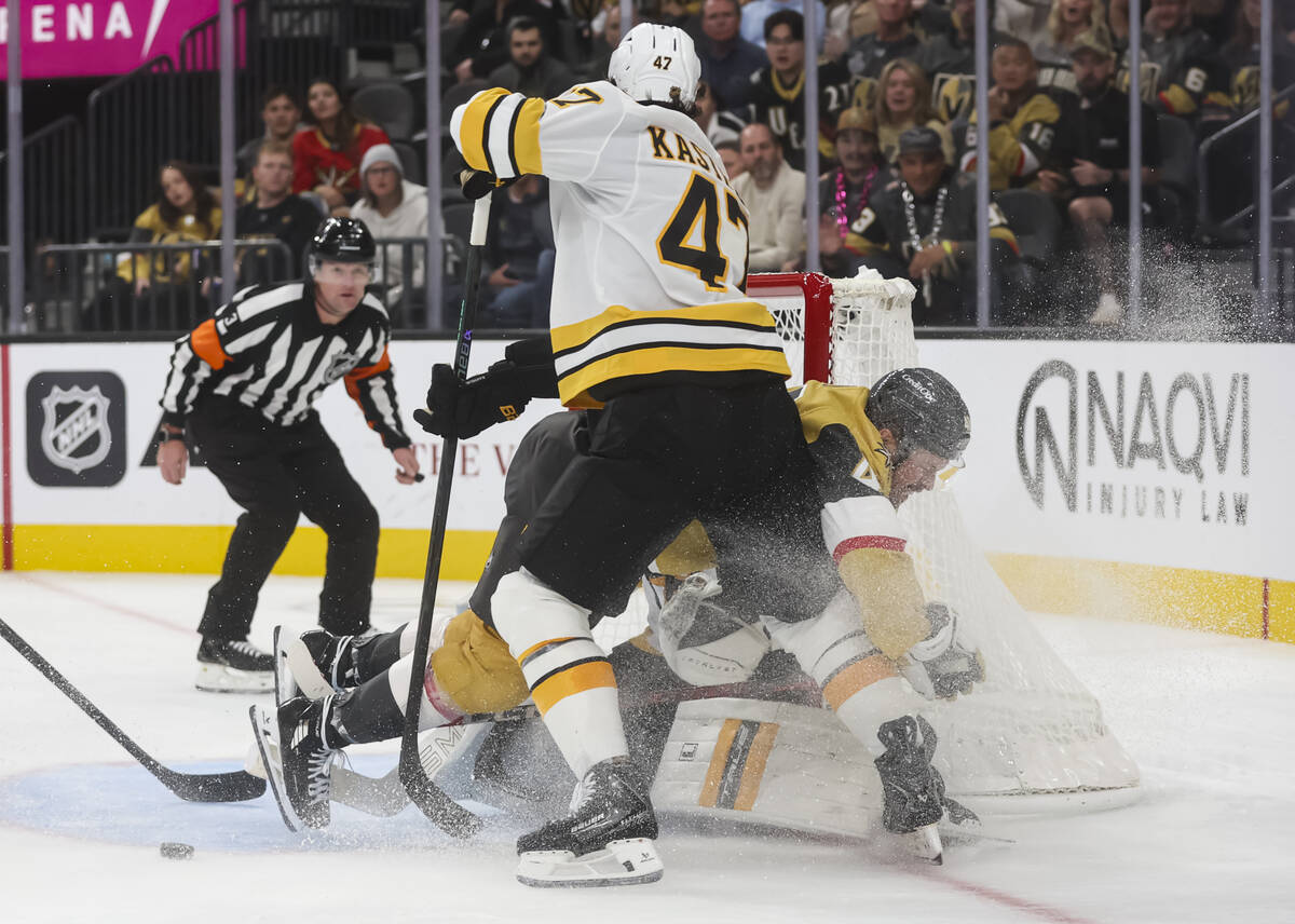 Golden Knights center Tomas Hertl (48) collides with Boston Bruins goaltender Jeremy Swayman (1 ...
