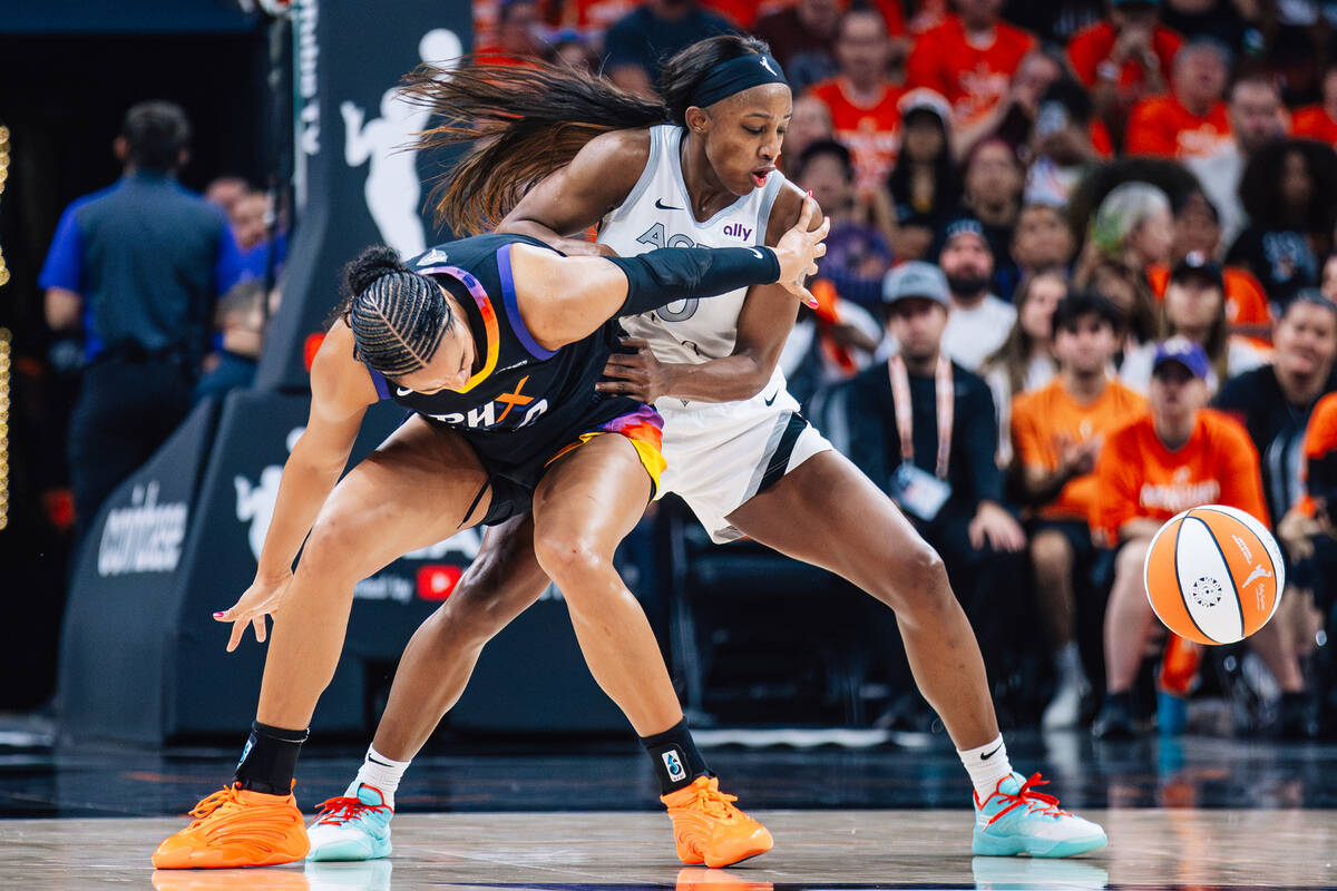Aces guard Jackie Young (0) and Phoenix Mercury forward Satou Sabally (0) try to get to a loose ...