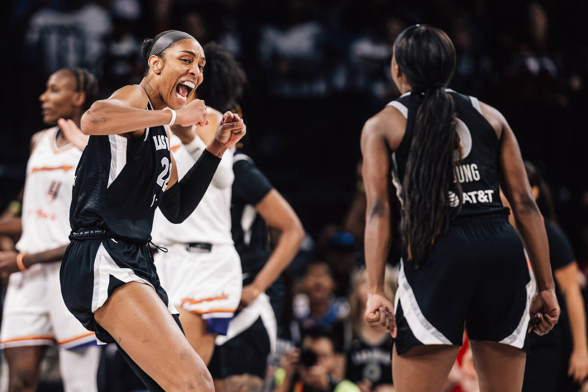 Aces center A'ja Wilson (22) celebrates with Aces guard Jackie Young (0) during game two o ...