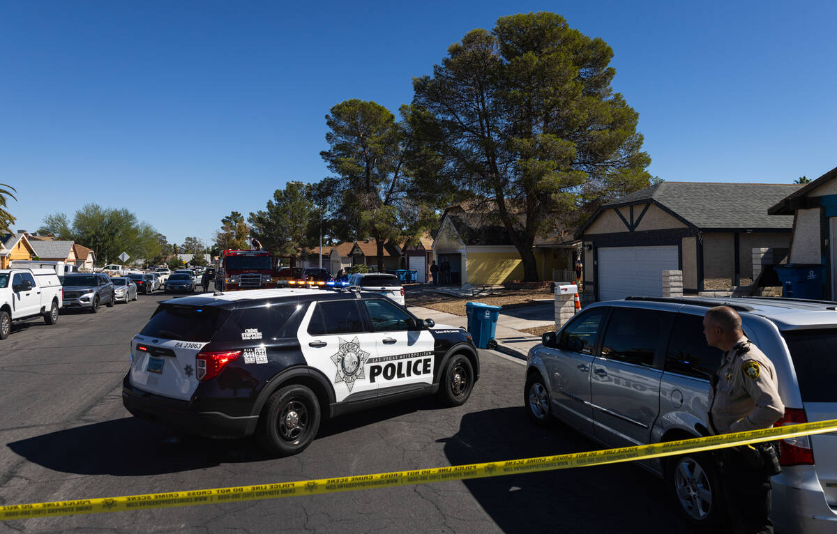 Members of the Metropolitan Police Department investigate a homicide at the 6200 block of Carme ...