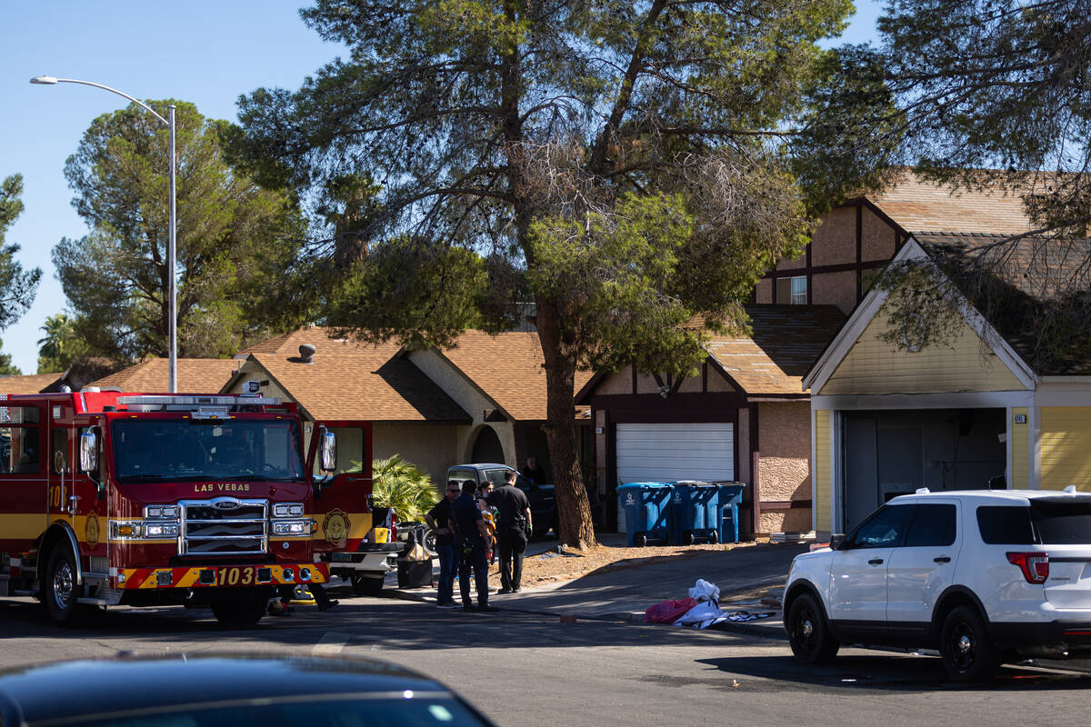 Members of the Metropolitan Police Department investigate a homicide at the 6200 block of Carme ...