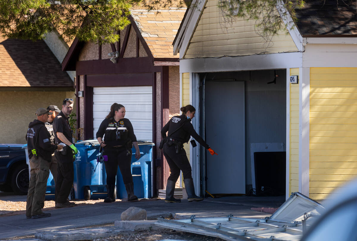 Members of the Metropolitan Police Department investigate a homicide at the 6200 block of Carme ...