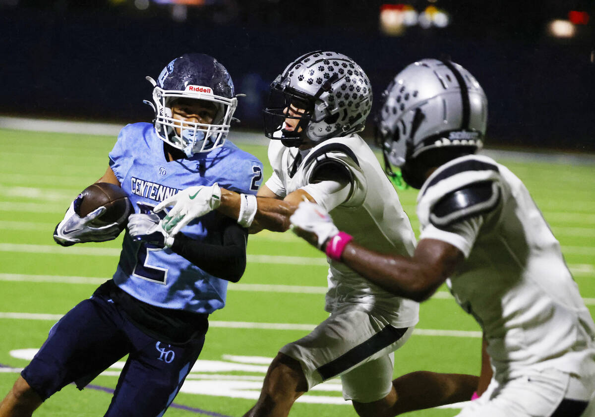 Centennial wide receiver Jordan Bostick (2) rushes against Palo Verde wide receiver Leo Templet ...