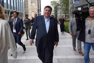 Illinois Governor JB Pritzker walks to River Point Park for a news conference, Aug. 25, 2025, i ...