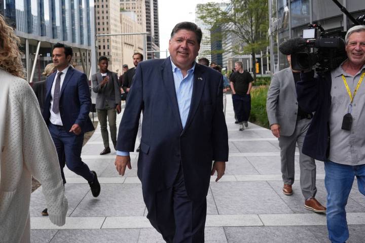 Illinois Governor JB Pritzker walks to River Point Park for a news conference, Aug. 25, 2025, i ...