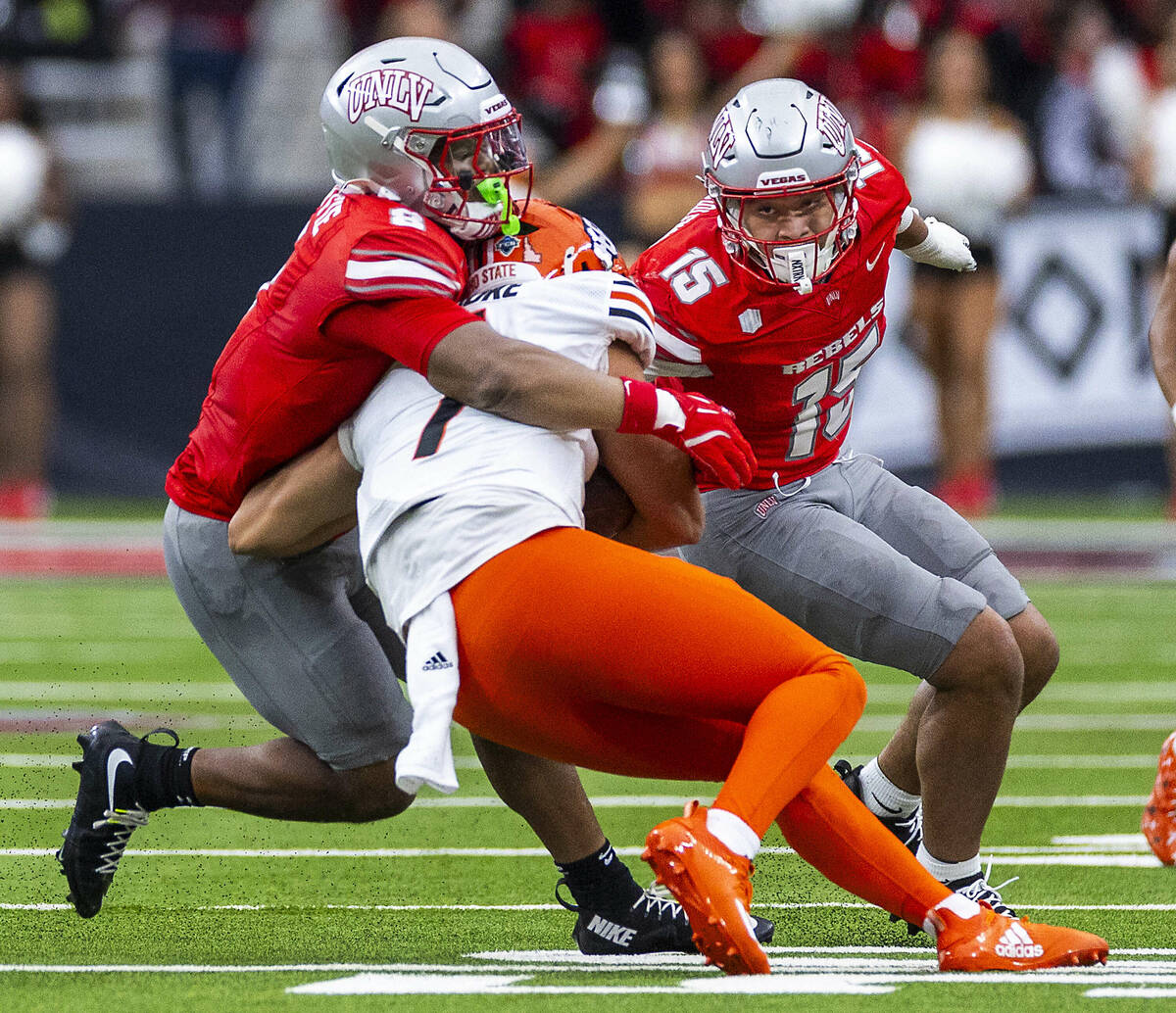 Idaho State Bengals quarterback Jordan Cooke (1) is stopped as he scrambles by UNLV linebacker ...