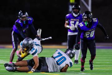 Silverado wide receiver Jayden Luangrath (16) goes down with the ball during a football game be ...