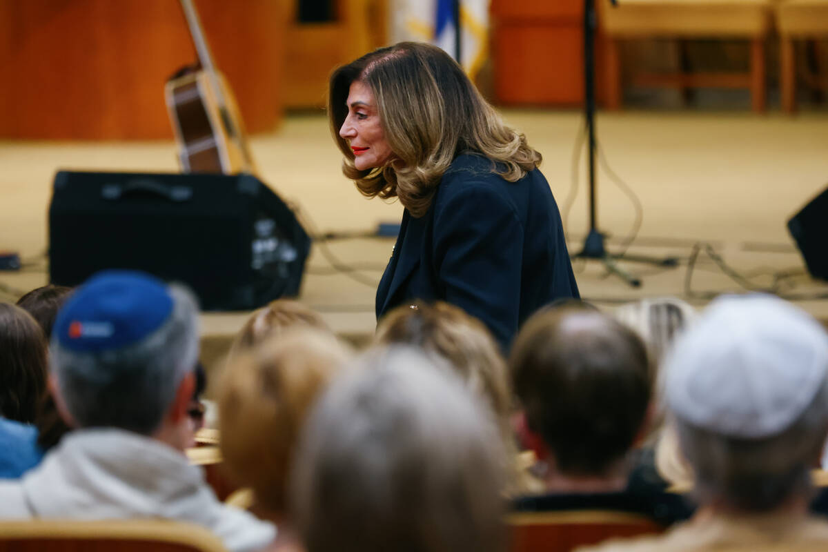 Las Vegas Mayor Shelley Berkeley walks back to her seat after lighting a candle during an Octob ...
