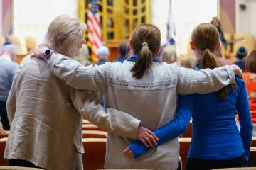 Community members hold each other as music plays during an October 7 attacks remembrance event ...