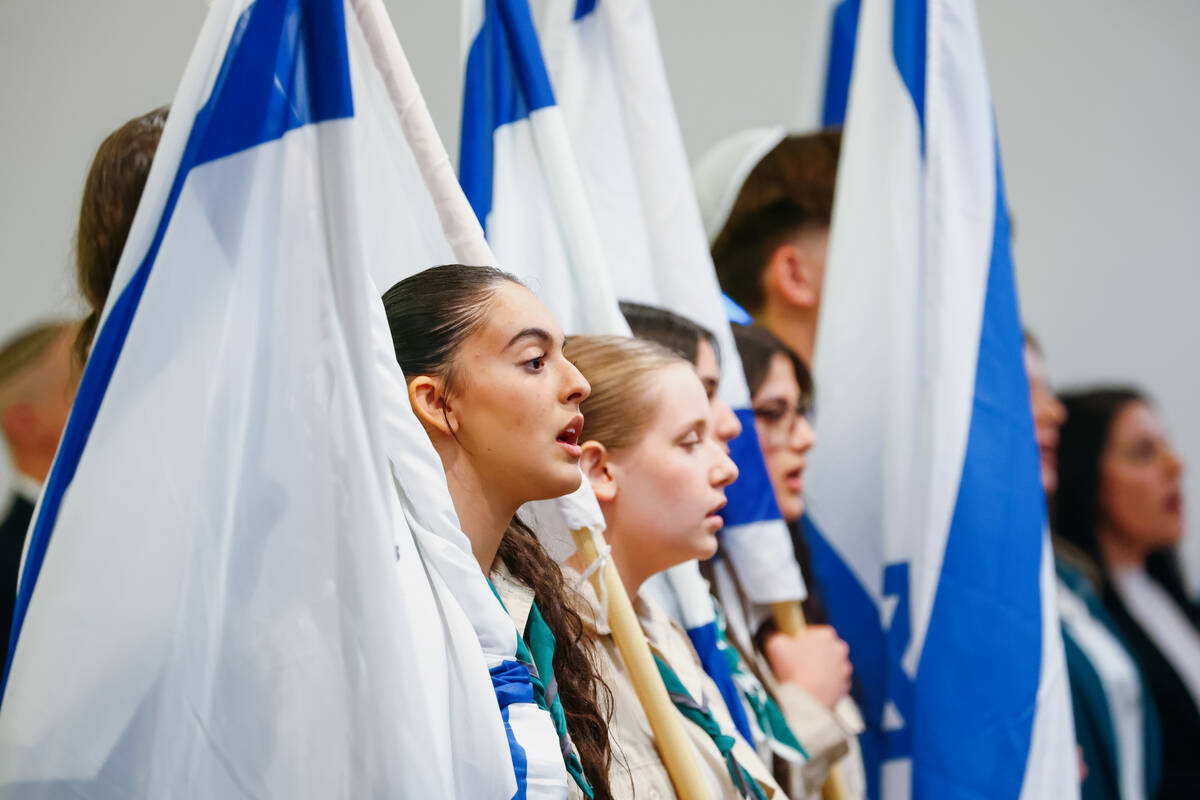 Attendees sing a closing song during an October 7 attacks remembrance event on Thursday, Oct. 1 ...