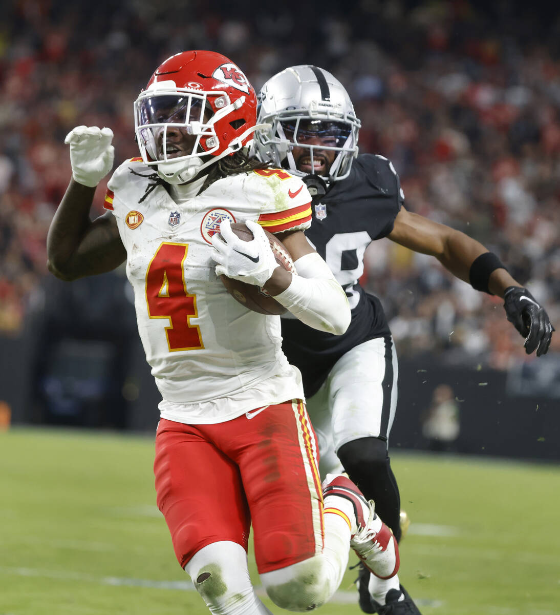 Kansas City Chiefs wide receiver Rashee Rice (4) runs past Raiders cornerback Nate Hobbs (39) a ...