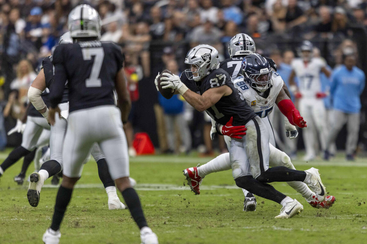 Raiders tight end Michael Mayer (87) hauls in a pass from quarterback Geno Smith (7) as Tenness ...
