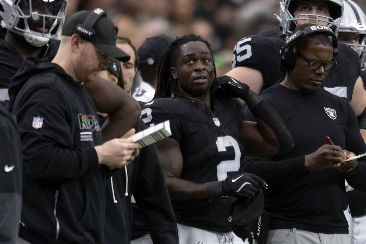 Raiders running back Ashton Jeanty (2) stands next to running backs coach Deland McCullough, ri ...