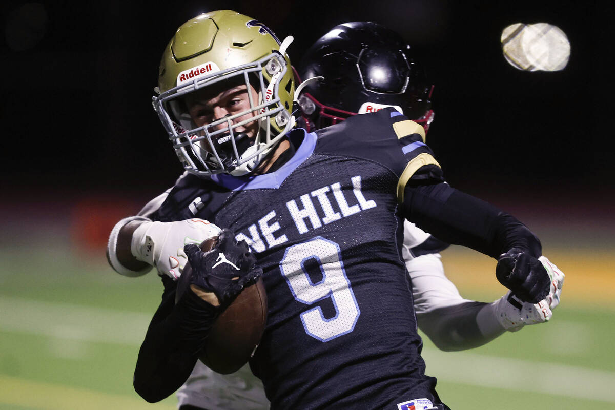 Foothill safety Brody Dobbs (9) is tackled by Desert Oasis safety Eric Johnson (3) after a muff ...