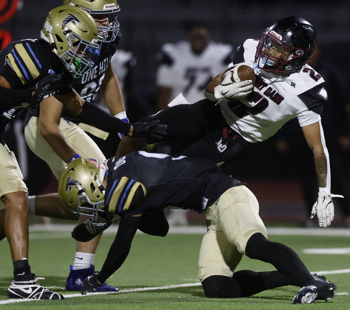 Desert Oasis running back Brycen Rabago (2) is tackled by Foothill safety Brody Dobbs (9) in th ...