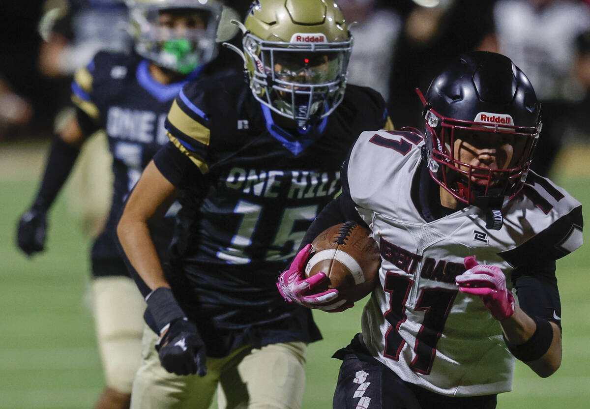 Desert Oasis wide receiver Holden Grobl (11) makes a big catch and run past Foothill cornerback ...