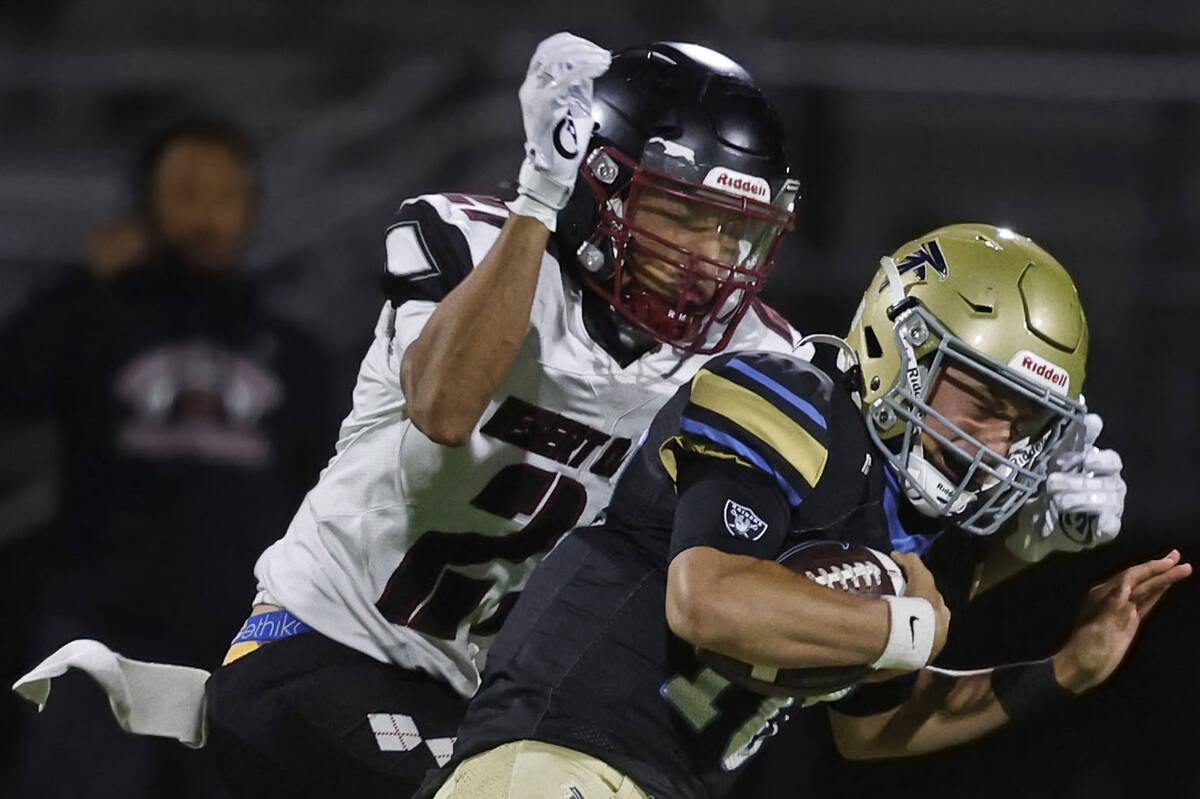 Foothill quarterback Ryder Dobbs (10) is tackled by Desert Oasis defensive back Devin Kai-Odina ...