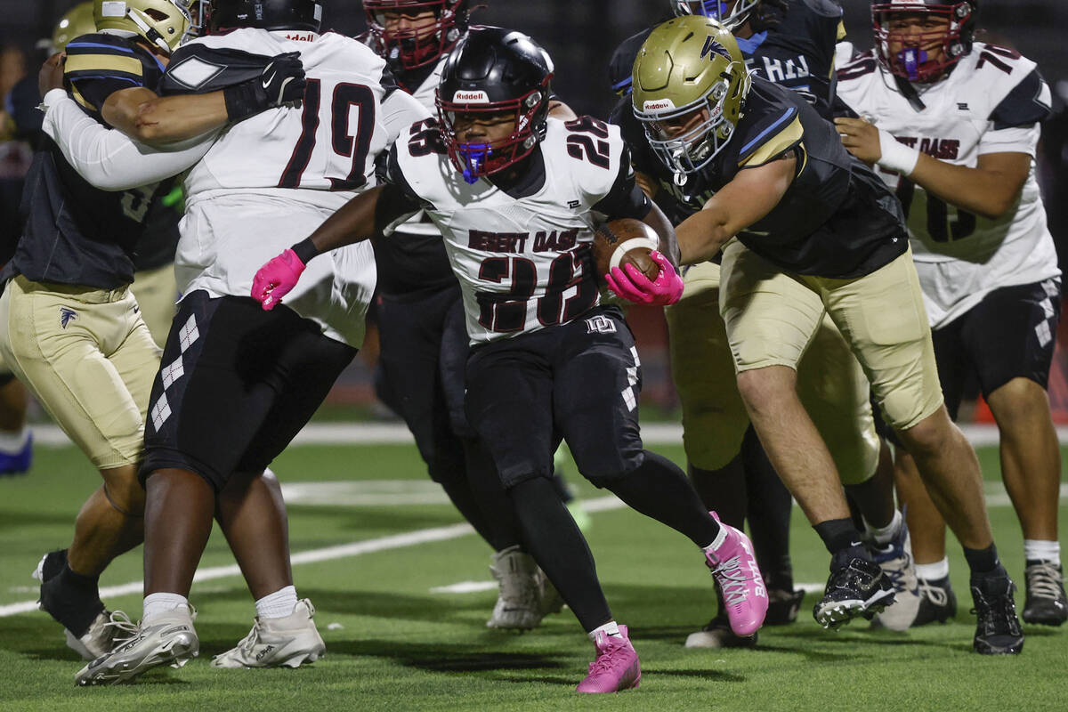 Desert Oasis running back Kyair Thomas (28) cuts up field past Foothill defenders in the second ...