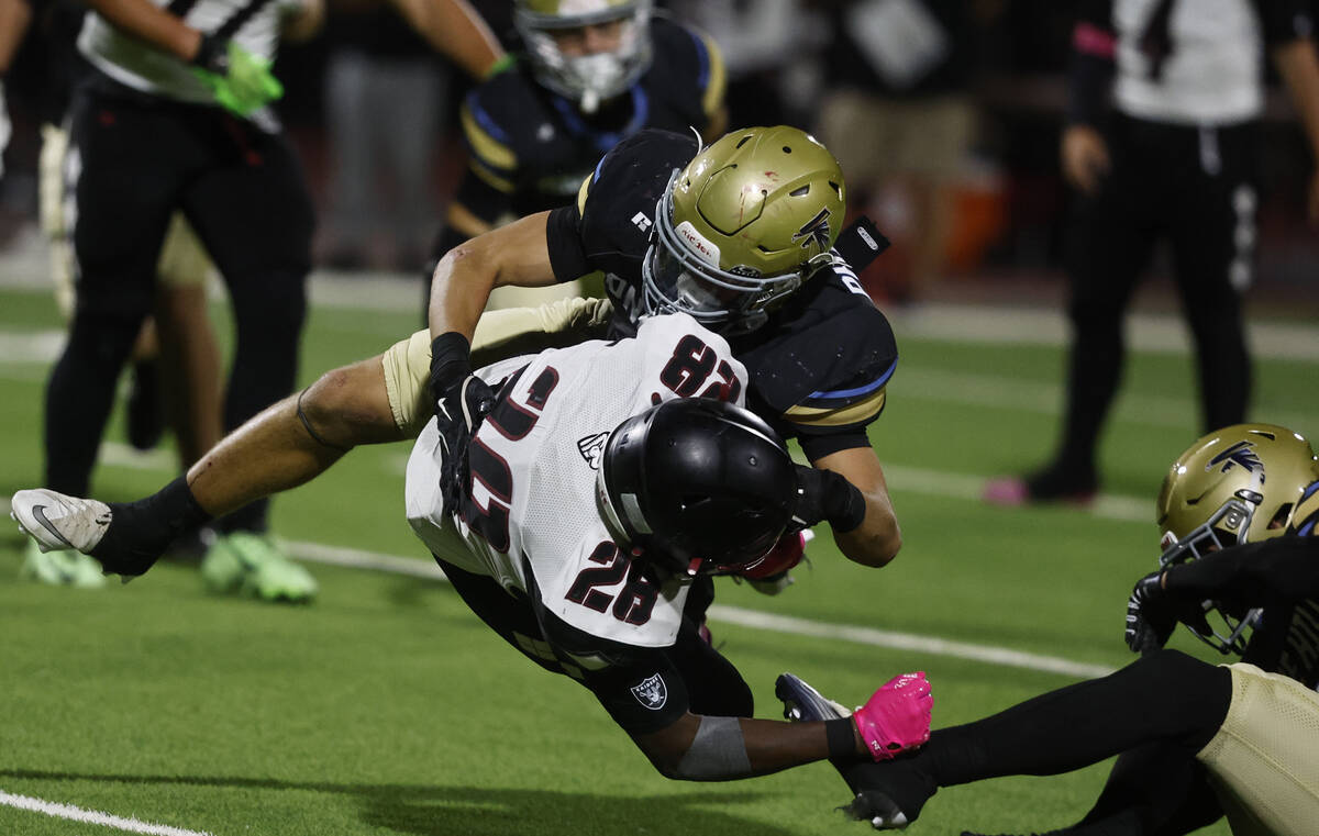 Desert Oasis running back Kyair Thomas (28) is tackled by Foothill linebacker Baylor Petashiski ...