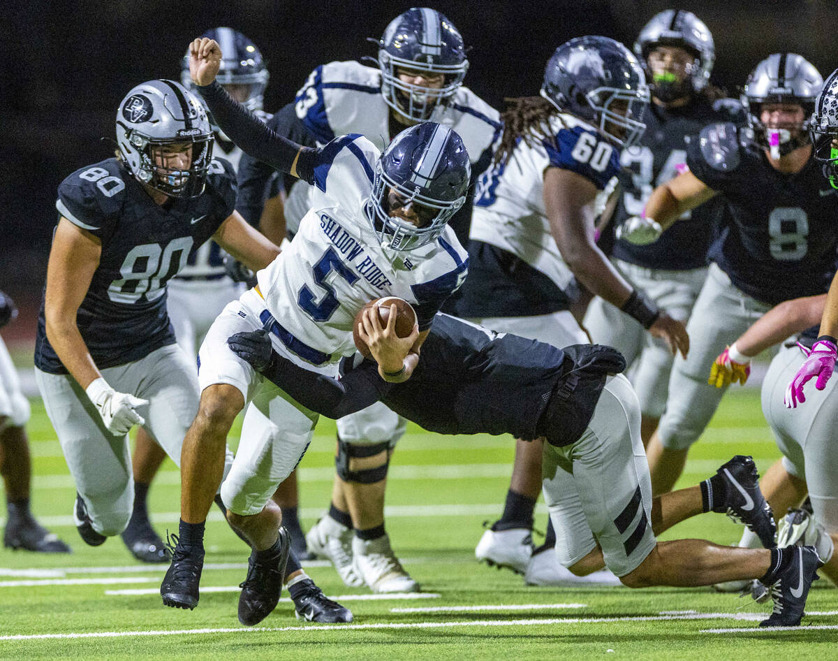 Shadow Ridge quarterback Isaiah Ruiz (5) works to break a Palo Verde tackle on a run during th ...
