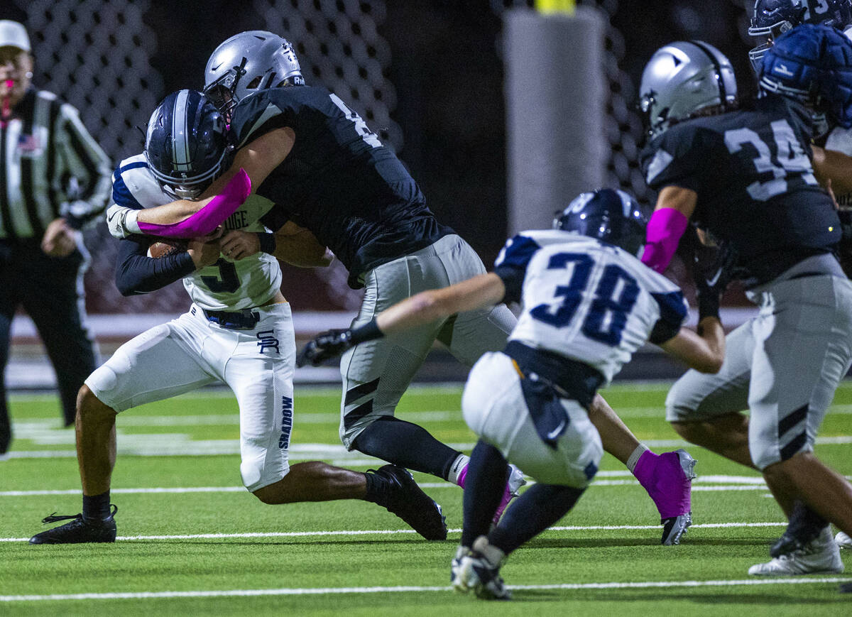 Shadow Ridge quarterback Isaiah Ruiz (5) is sacked by Palo Verde's Kyle Johnson (8) during ...