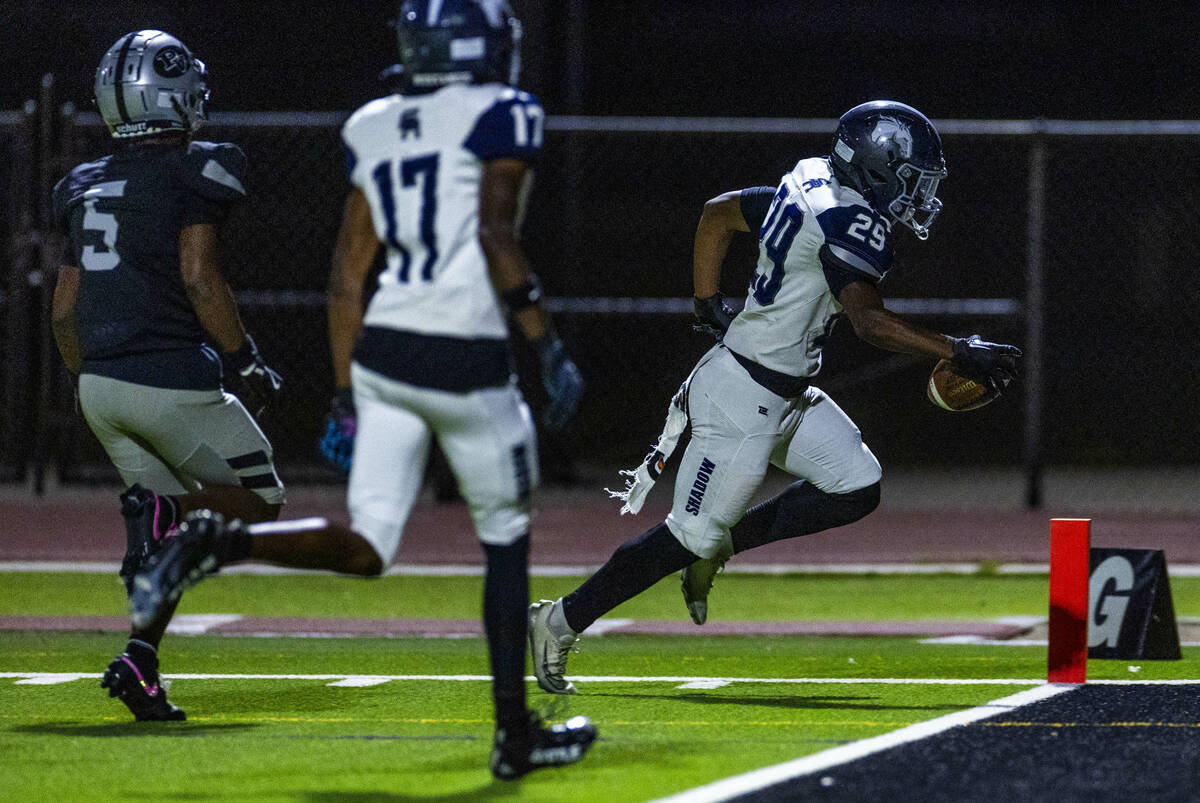 Shadow Ridge runner Trevin Young (29) scores a touchdown as Palo Verde's Cory Hood (5) arr ...