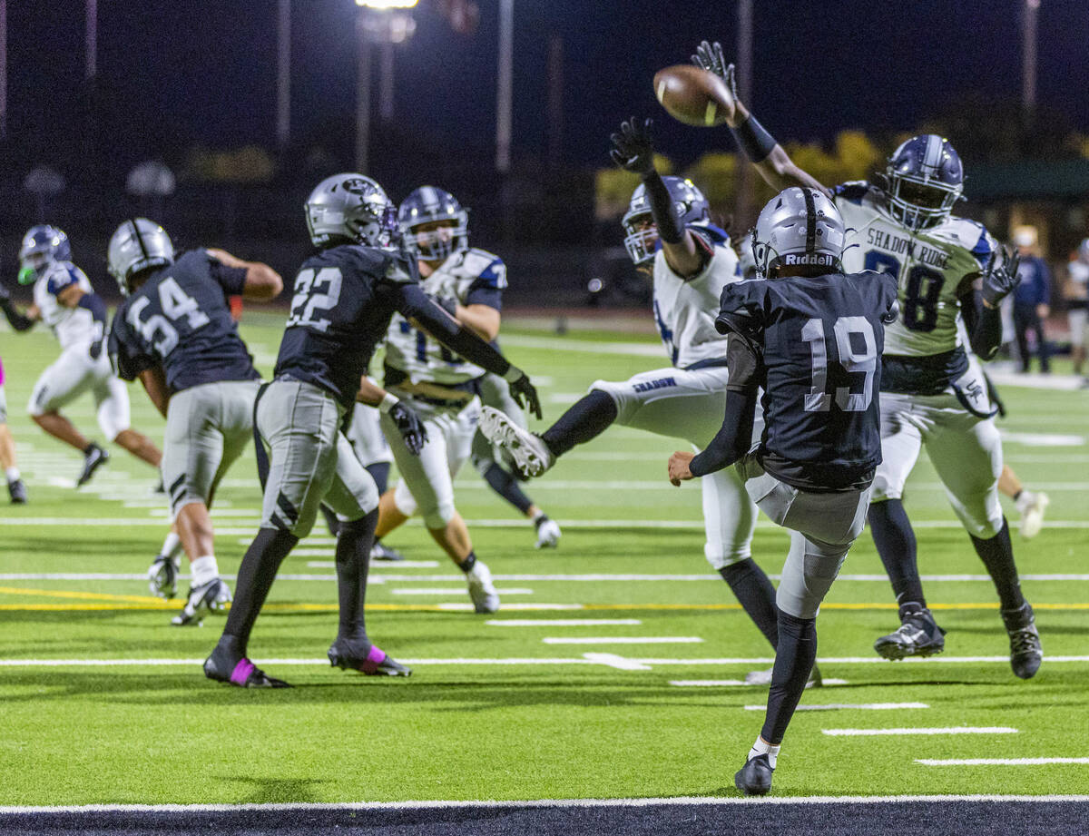 Shadow Ridge's Marcus Jennings (88) etends to get a piece of a ball mounted by Palo Verde& ...