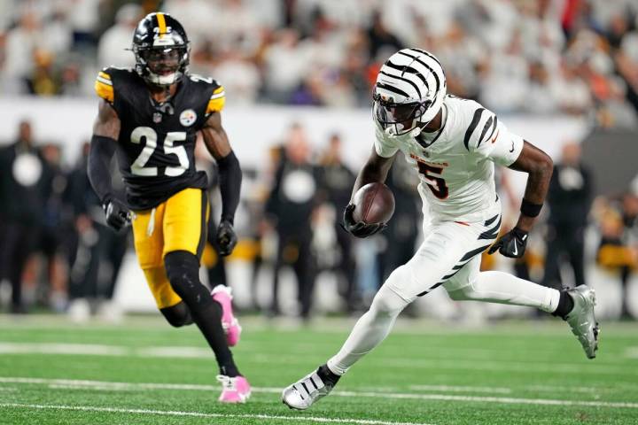 Cincinnati Bengals wide receiver Tee Higgins (5) heads for the end zone and a touchdown after t ...
