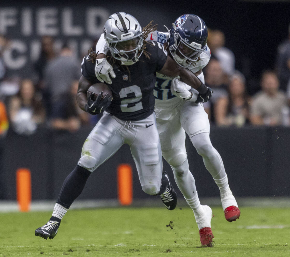 Raiders running back Ashton Jeanty (2) pushes off Tennessee Titans cornerback L'Jarius Sne ...