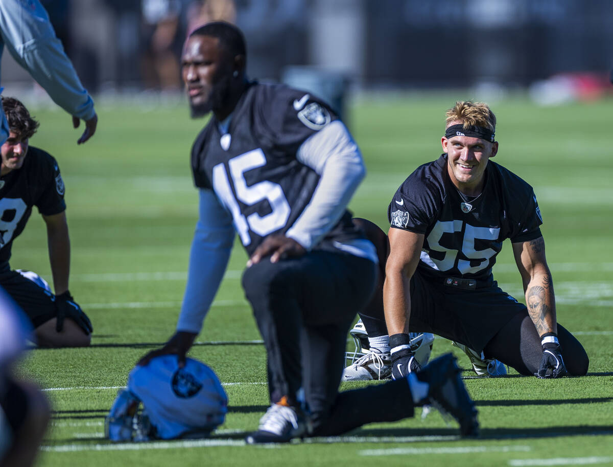 Raiders linebacker Cody Lindenberg (55) stretches with teammates during the first day of traini ...