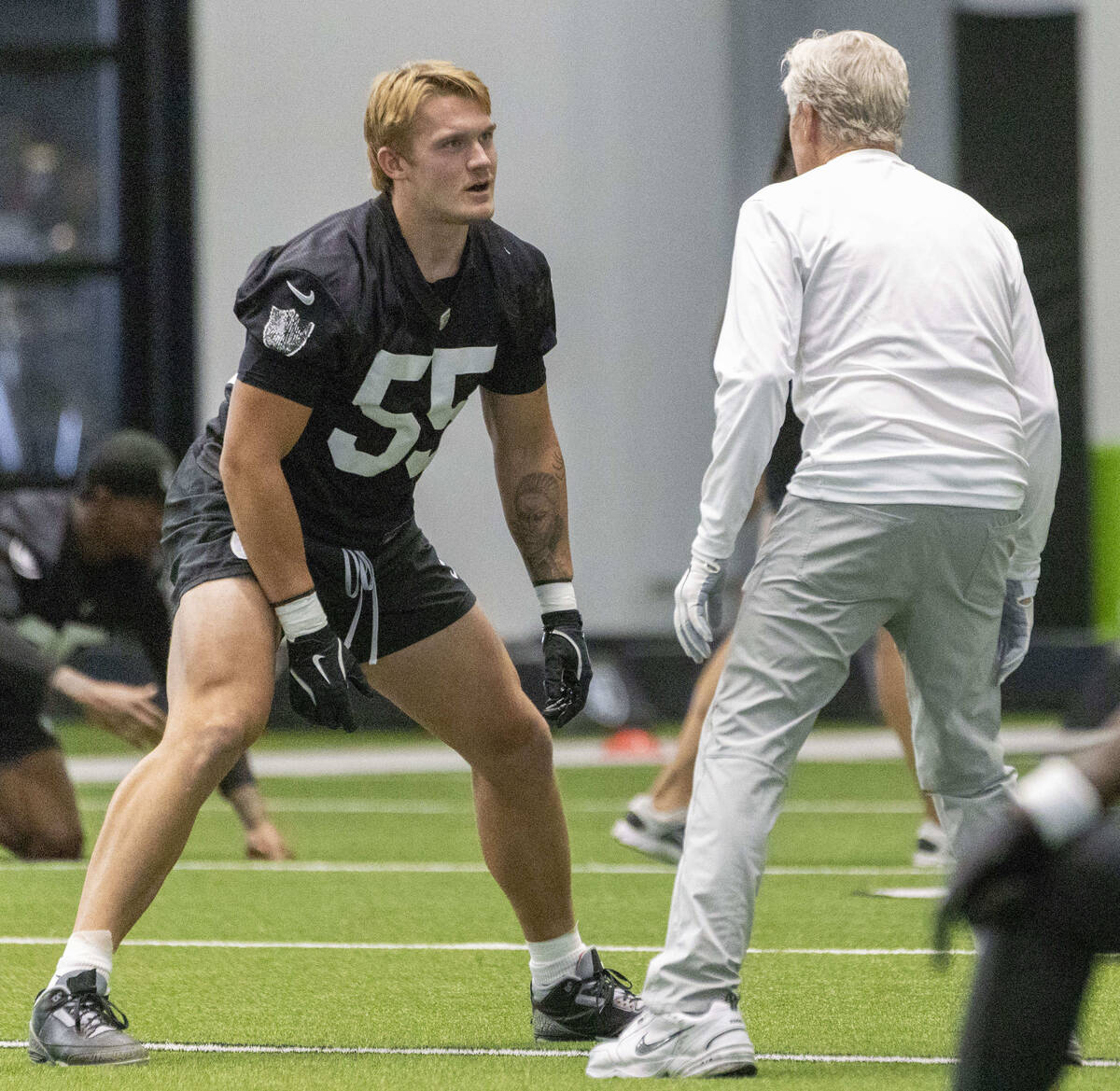 Raiders linebacker Cody Lindenberg (55) speaks with head coach Pete Carroll during a team pract ...