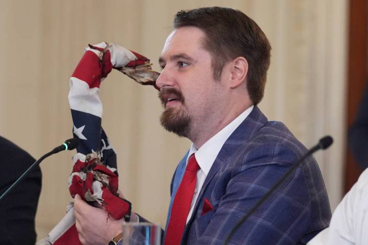 Nick Sotor holds an American flag that was partially burned in Portland, Ore., during protests, ...