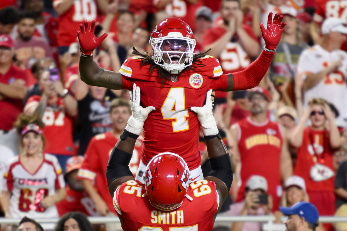 Kansas City Chiefs wide receiver Rashee Rice (4) is lifted by Chiefs guard Trey Smith (65) afte ...