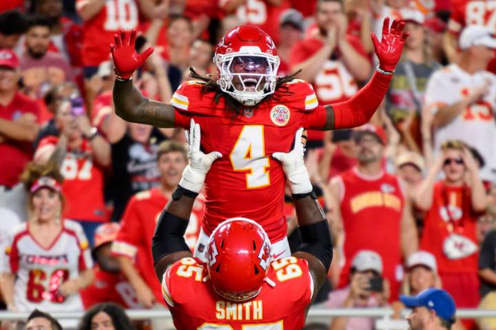 Kansas City Chiefs wide receiver Rashee Rice (4) is lifted by Chiefs guard Trey Smith (65) afte ...