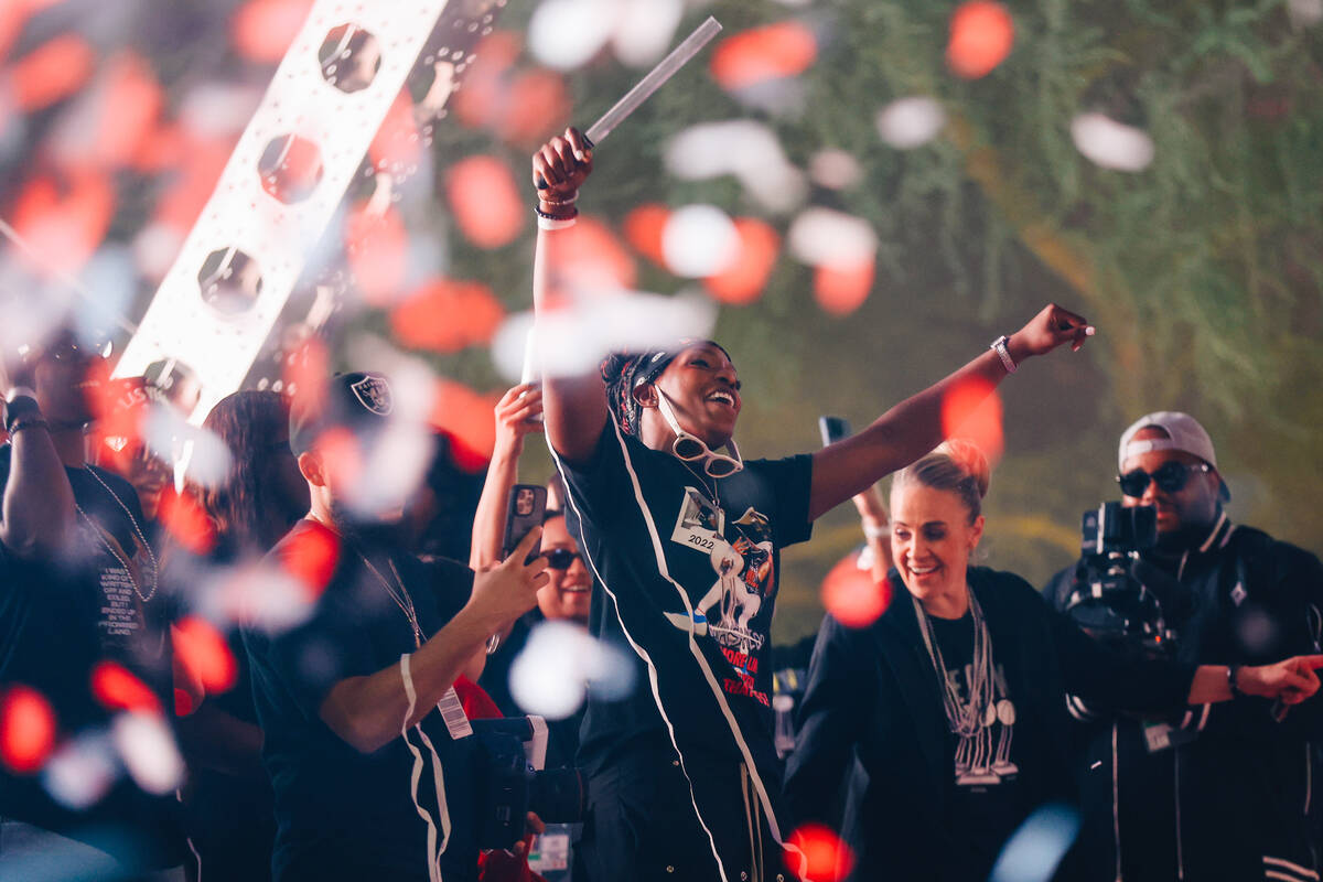Aces guard Chelsea Gray celebrates during the Aces’ championship parade on the Strip Fri ...