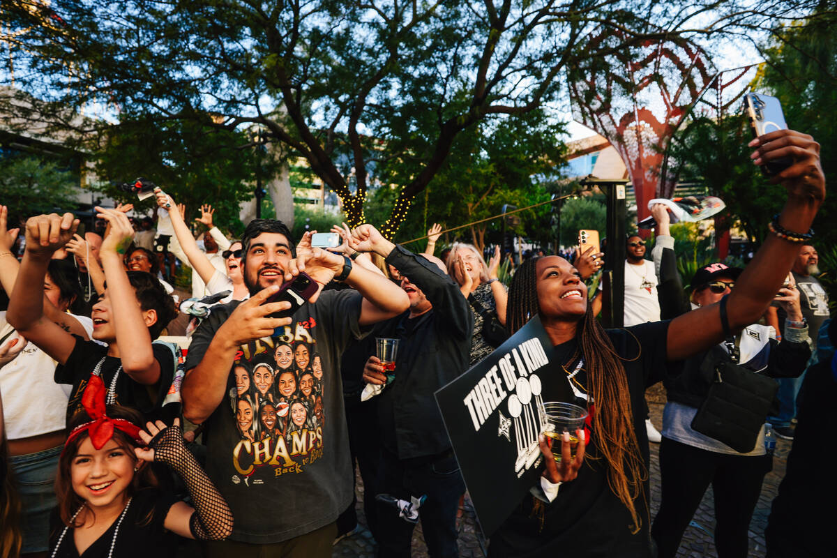 Fans celebrate during the Aces’ championship parade on the Strip Friday, Oct. 17, 2025, ...