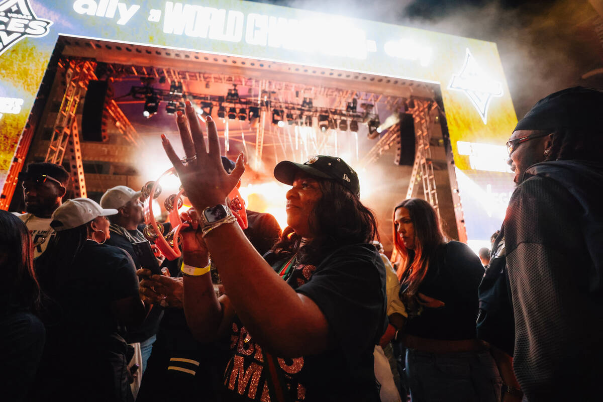 Aces center A'ja Wilson’s mom, Eva Wilson, plays the tambourine during the Aces&#x2 ...