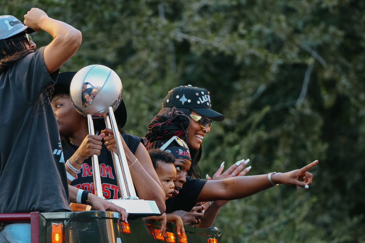 Aces players Chelsea Gray, her son Lennox, 1, and A’ja Wilson stand at the front of the ...