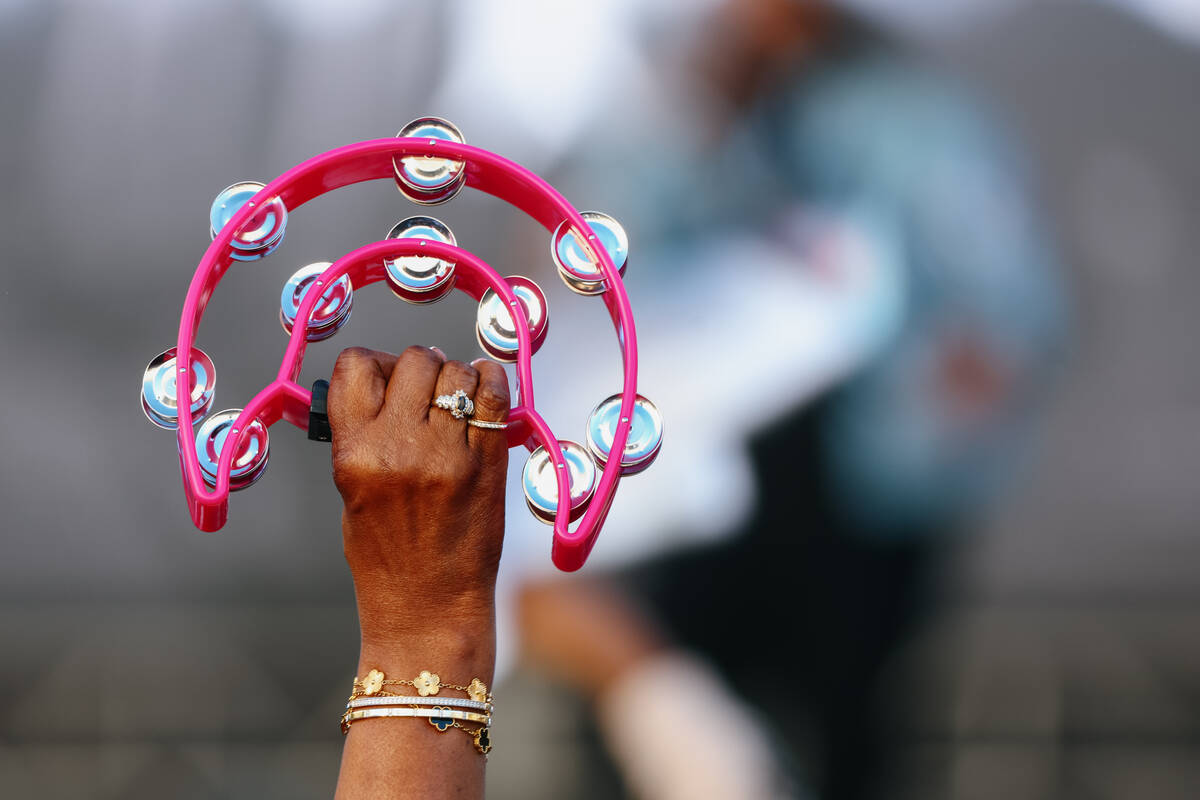 A fan holds up a tambourine during the Aces’ championship parade on Friday, Oct. 17, 202 ...
