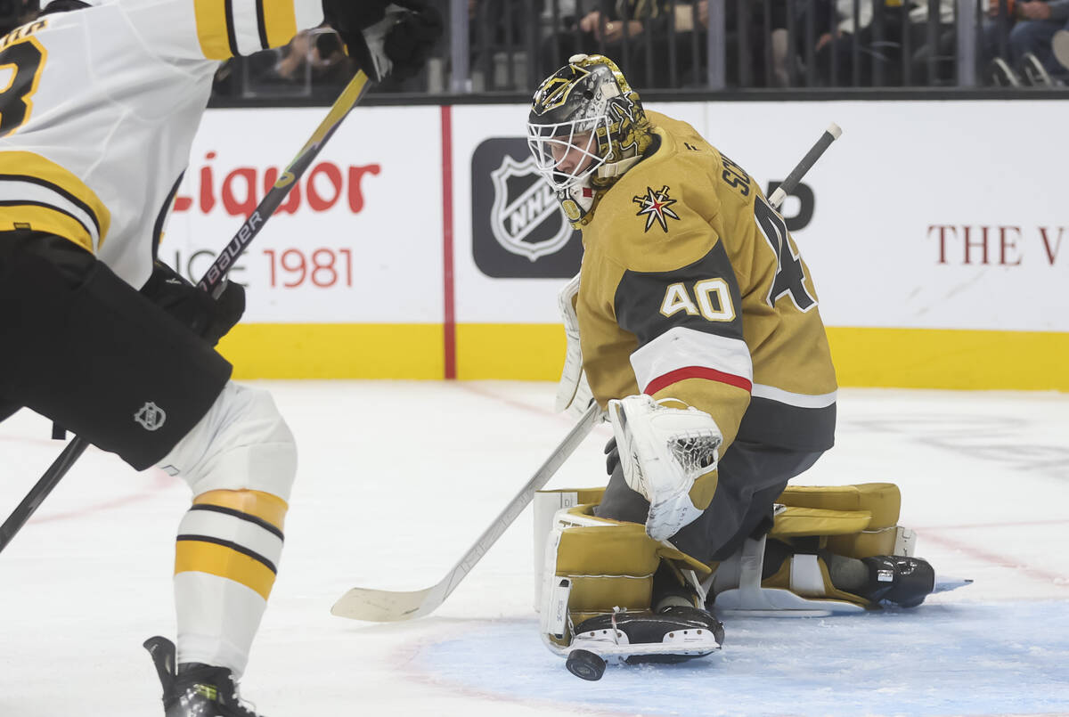 Golden Knights goaltender Akira Schmid (40) blocks a shot from the Boston Bruins during the sec ...